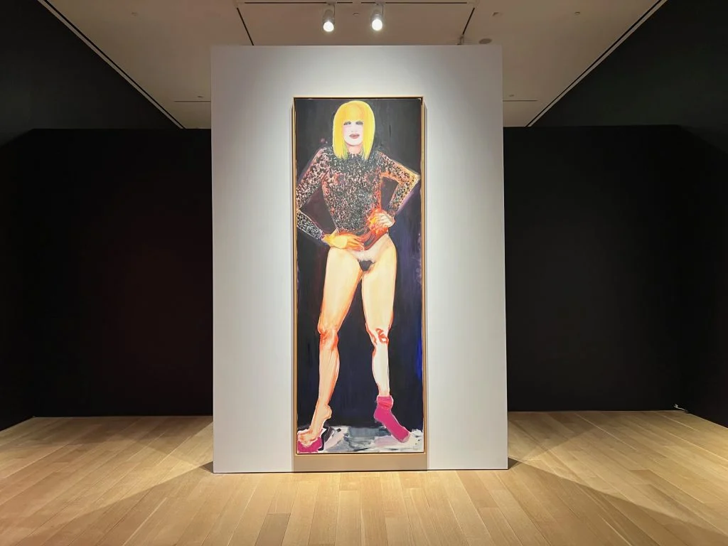 A bold, expressive painting of a figure with blonde hair wearing a glittering top and pink socks, striking a confident pose against a dark, abstract background.